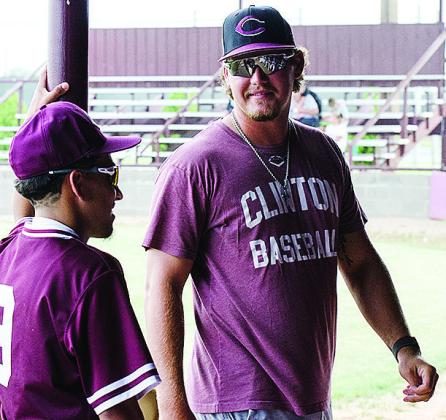 New Clinton baseball coach Cooper Rhoads, right, talks with Azreal Fierros prior to the start of the Reds’ home game against Weatherford this summer. CDN | Sam Goodwyn