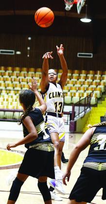 Seventh-grader Ale-Jia Lacy shoots over a Woodward defender during a home game against the Lady Boomers. CDN | Sam Goodwyn