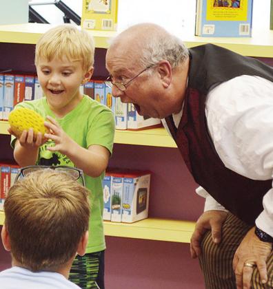 Skeeter Martin, left, is amazed by magician Doc Rogers at the Clinton Public Library’s Summer Reading Program first weekly performance. CDN | Micah Ashcraft