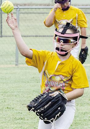Claire Kreizenbeck throws the ball during warm-ups prior to the start of Arapaho-Butler’s softball game in the OK Kids 8U Softball Tournament at Shumacher Fields at Acme Brick Park. CDN |Sam Goodwyn