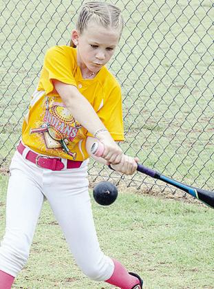 Hope Boone focuses on the ball as she goes through batting practice prior to the start of the OK Kids 8U Softball Tournament. CDN |Sam Goodwyn