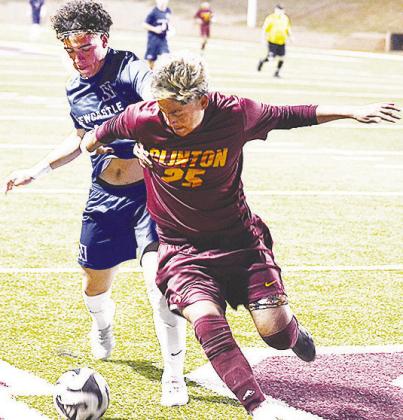 Clinton’s No. 25 Andrew Barron fights with a Newcastle player for control of the ball during the Reds’ 1-0 victory Tuesday over the Racers in the Tornado Bowl. CDN | Sam Goodwyn