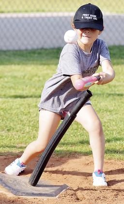 Valarie Tobias swings mightly at the ball during a Noon Lion’s Club T-Ball game at Schumacher Fields at Acme Brick Park. CDN | Sam Goodwyn