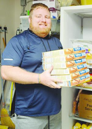 Greg Ferrell loads a stack of holiday pumpkin pies into a freezer in the Cornerstone Church kitchen, ahead of the annual Thanksgiving lunch served on Thanksgiving Day. CDN | Micah Ashcraft