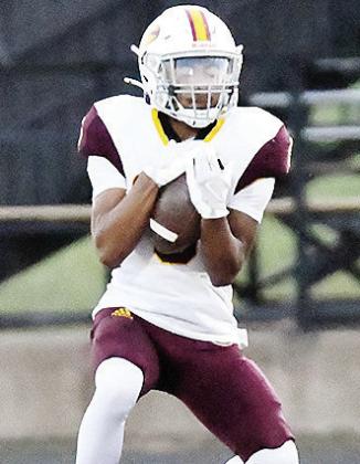 Clinton’s Jesus Gutierrez secures the ball in his arms after receiving the punt during the Red Tornadoes’ road game against Woodward. CDN |John Kinsey