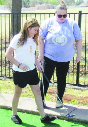 Preslie Hines, left, and Amanda Hines plan their approach and the next best angle to hit at Route 66 Miniature Golf Course. CDN | Christian Jacobsen