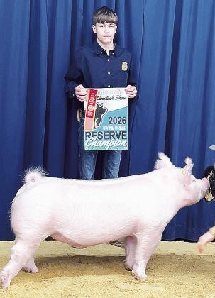 Chisum Roper poses with his pig after being crowned Reserve Champion.