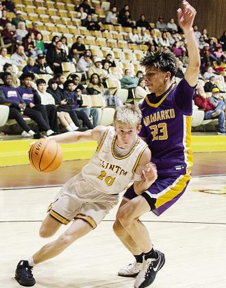 Clinton’s Ryder Adams, left, drives against the Anadarko defender during the Reds’ home game against the Warriors Tuesday in the Tornado Dome. CDN | Sam Goodwyn