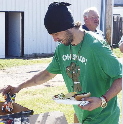 Brandon Woods grabs some chips after filling his plate with a couple of hotdogs during the cookout.