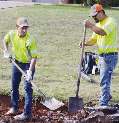 Derek Murray, left, and Alex Fraser work to remove old concrete and asphalt Tuesday on Old Route 66 on the west edge of town. CDN | Christian Jacobsen