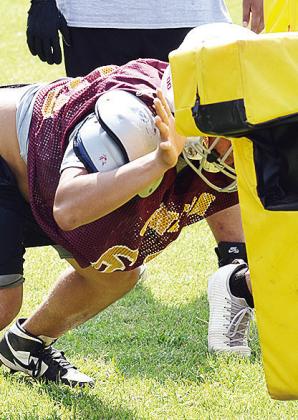 Colton Pool lunges at the blocking dummy during practice at the middle school. CDN |Sam Goodwyn