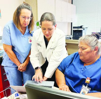 From left, Kristi Bomgren, Dr. Nadia Azuero, and Ana Reyes look over some test results in Dr. Azuero’s office at Clinton Regional Hospital. CDN | Shiann Dawson