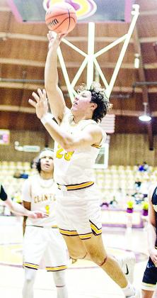 No. 23 Easten Powell jumps through the air for the layup during Clinton’s home game with Woodward. CDN | Sam Goodwyn