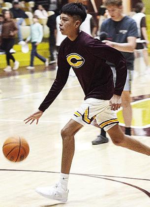 Clinton’s Rufus Whiteman-Ellis dribbles the ball during warmups prior to the Reds recently taking on district foe Elk City in the Tornado Dome. CDN | Sam Goodwyn