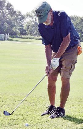 Tony Bowman focuses on the ball as he prepares to send it flying during a round of golf at Riverside. CDN | Sam Goodwyn