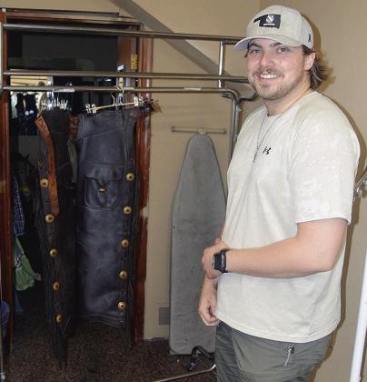 Reece McAbee shows the costume chaps he is drying and treating Thursday at the Southwest Playhouse. CDN | Christian Jacobsen