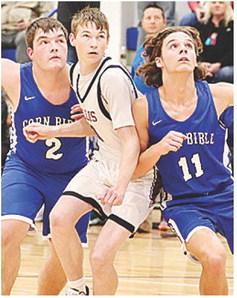 CBA’s Luke Zybach, left, and Braxton Sousa, right, battle with a Hollis player last week during the second round of the CBA Basketball Tournament. CDN |Courtesy Photo