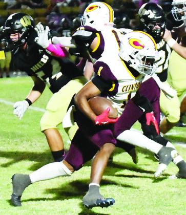 No. 1 Derren Hester carries the ball, while his teammate Aaron Ramirez provides a block for him during Clinton’s win Thursday over Woodward. CDN | John Kinsey