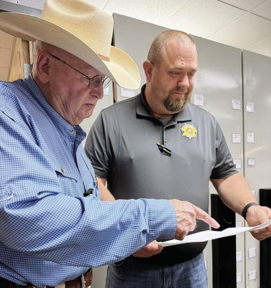 Custer County Sheriff Dan Day, left, and Investigator Ray Hammans together go over the details of a recent case. CDN | Shiann Dawson