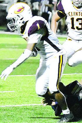 No. 1 Derren Hester fights through a leg tackle during Clinton’s game Friday in Kingfisher. CDN | John Kinsey
