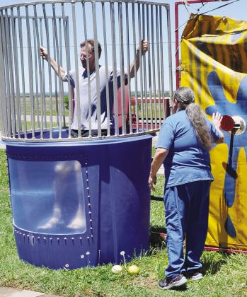 Who needs to use a ball to hit the target? That’s the mindset of Cathy Bridges, pharmacist technician, as she pops the plate to send Pharmacy Director Cris Hickerson into the dunk tank to wrap up “Hospital Week” activities at Clinton Regional last w