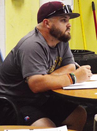 Clinton High School teacher and football coach Jacob Lee focuses Monday afternoon on the instruction given during his CDL and bus driving lesson given at Clinton Public Schools’ Bus Barn by mechanic and bus instructor Rick Challis. CDN | Micah Ashcraft