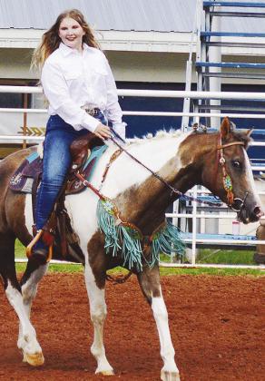 Macie Hall rides her horse in front of the judges as part of the Clinton Round-Up Club’s Rodeo Royalty competition at the Clinton Rodeo Grounds. CDN | Micah Ashcraft