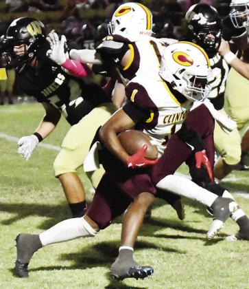 No. 1 Derren Hester carries the ball, while his teammate Aaron Ramirez provides a block for him during Clinton’s win Thursday over Woodward. CDN | John Kinsey