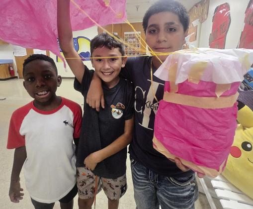 From left, Elijah Kirkendoll, Luke Rodriguez, and Iker Guzman show off their creation to use during an egg drop activity at REDS365. CDN | Courtesy photo