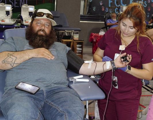 Chad Boggs, left, with the help of phlebotomist Diana Ramirez donates to the blood drive Tuesday at the First Christian Church’s Family Life Center. CDN | Christian Jacobsen
