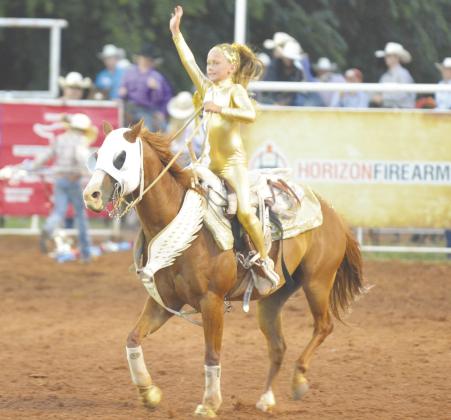 Layne Pickard waves to the crowd after performing a trick during the rodeo.
