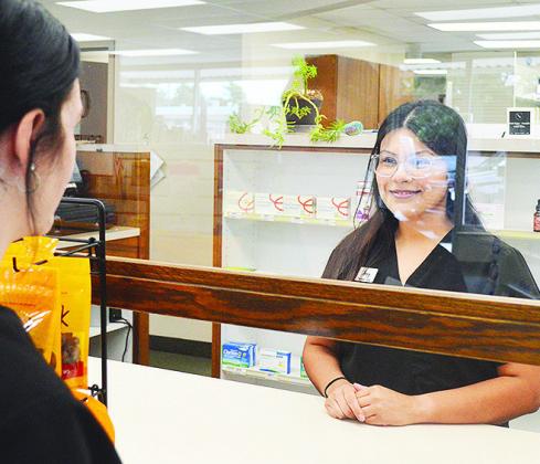 Store Clerk Amy Salazar helps a customer fill their prescription behind the counter at Salisbury Pharmacy. CDN | Micah Ashcraft