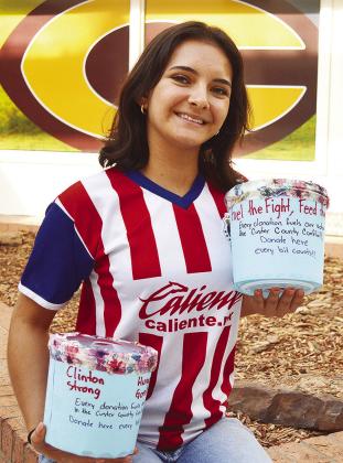 Clinton High School Key Club President Idalia Pelayo shows off several of the Custer County Conflict Food Drive collection buckets CDN | Micah Ashcraft
