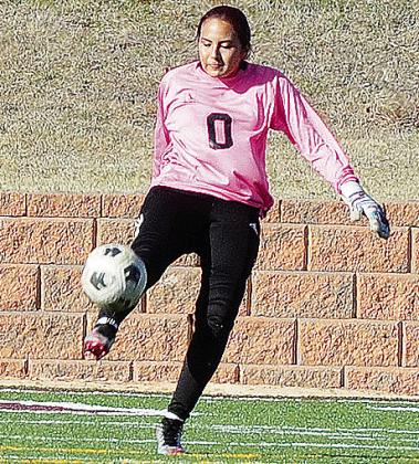 Clinton’s Ciela Burns punts the ball during a game for the Lady Reds last year in the Tornado Bowl. CDN | Sam Goodwyn