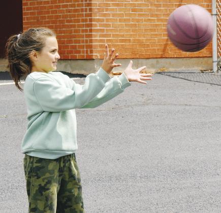 Jordyn Patton is playing a game of pass the ball, and is ready for the catch at Southwest Elementary School. CDN | Christian Jacobsen