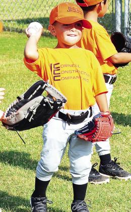 Cal Adams pulls his arm back as he prepares to throw the ball during warmups prior to one of his Noon Lions Club T-Ball games. CDN | Sam Goodwyn