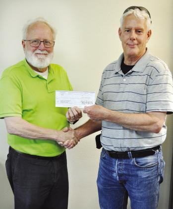 It’s not every day a check for $6,255,272 is written, much less delivered, but that was the case Wednesday when Clinton City Manager Robert Johnston, left, handed a check for that amount representing the City of Clinton’s share of the Exit 65 Project 