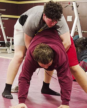 Clinton’s Layne Spitz, top, wrestles with Isaiah Dustman during practice in the wrestling room Wednesday. CDN | Sam Goodwyn