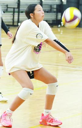 Ella Redshin return serves the ball over the net during practice Tuesday. CDN | Sam Goodwyn