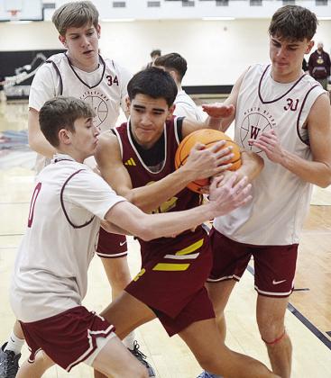 JJ Ruiz, center, battles for the rebound against a trio of Weatherford defenders. CDN | Sam Goodwyn