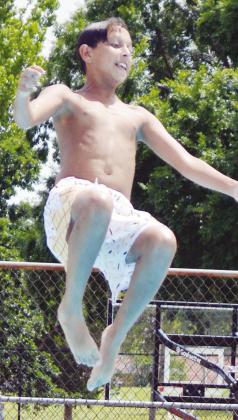 Kaileb Tyler starts his forward facing backflip into the Clinton Public Pool. CDN | Christian Jacobsen