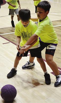 Kai Jefferson, right, knocks the ball out of Charlie Moss’ hands during warm-ups prior to the second-grade boys’ championship game for Southwest at the Tornado Bowl. CDN | Sam Goodwyn