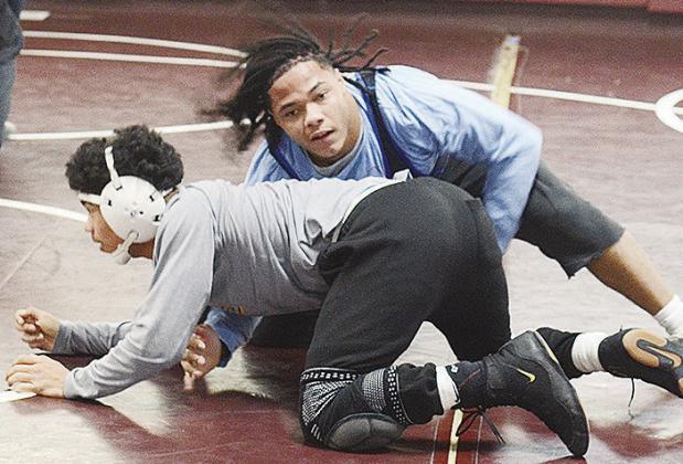 Clinton’s Malachi Lorne, top, attempts to wrap himself around Tyson Brookter during wrestling practice. CDN | Sam Goodwyn