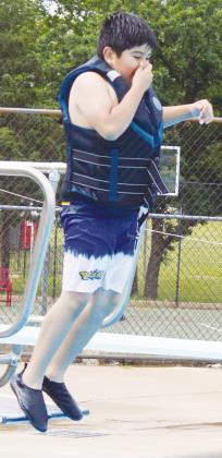 Aiden Perez jumps off of the diving board for the first time ever during Summer Playground at the Clinton Pool. CDN | Christian Jacobsen