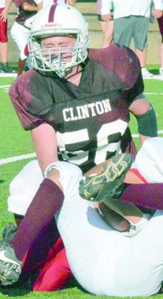 Clinton seventh-grader Rayden Walker finishes a tackle during a recent middle school football game.