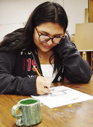CHS sophomore Analy Venegas sketches a still life of a mug during her art class at Clinton High School. CDN | Micah Ashcraft