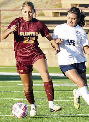 No. 23 Giana Burns tries to hold off the PC West defender as she goes downfield with the ball during Clinton’s home win Tuesday against the Lady Patriots. CDN | Sam Goodwyn