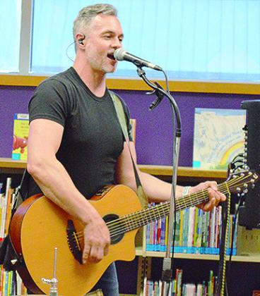 Brendan Parker, part of the musical duo Spaghetti Eddie, performs recently at the Clinton Public Library for the Summer Reading Program’s weekly performance. CDN | Micah Ashcraft