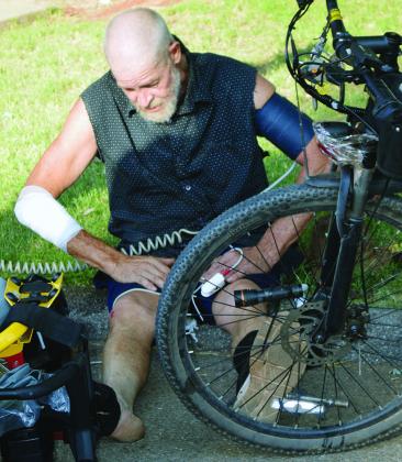 Jeff Keeton recovers after he said three local dogs ran up to him on his bike and tried to bite him Friday morning at N. 14th and Prairie Chief Avenue. He said he was fine with no broken bones, and only a road rash to his arm and knee. CDN | Christian Jacobsen