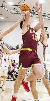 No. 13 Ethan Lofland fights through traffic as he goes up for the shot during Clinton’s road game Tuesday against Weatherford. CDN | Sam Goodwyn